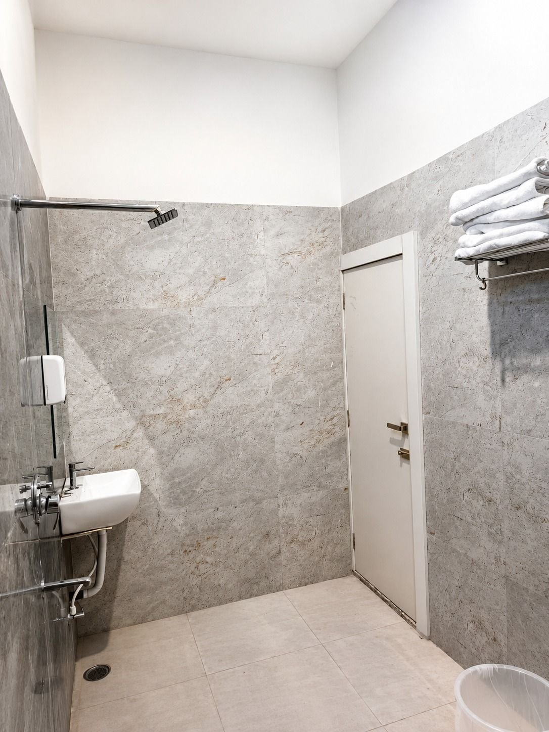 Attached bathroom at The Ambay Villa Udaipur with shower area and fresh towels