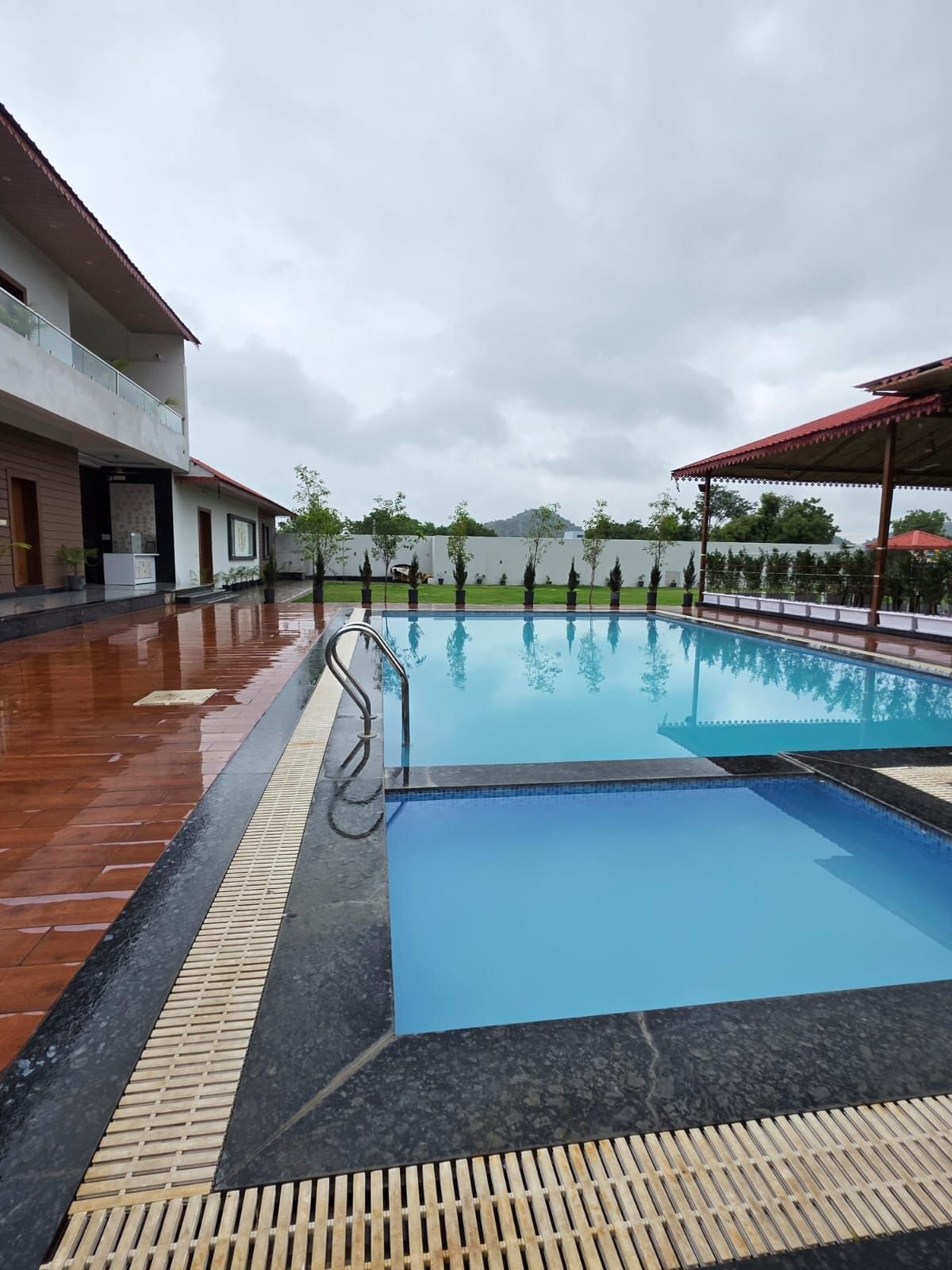 Separate shallow kids' pool beside the main pool at The Ambay Villa Udaipur