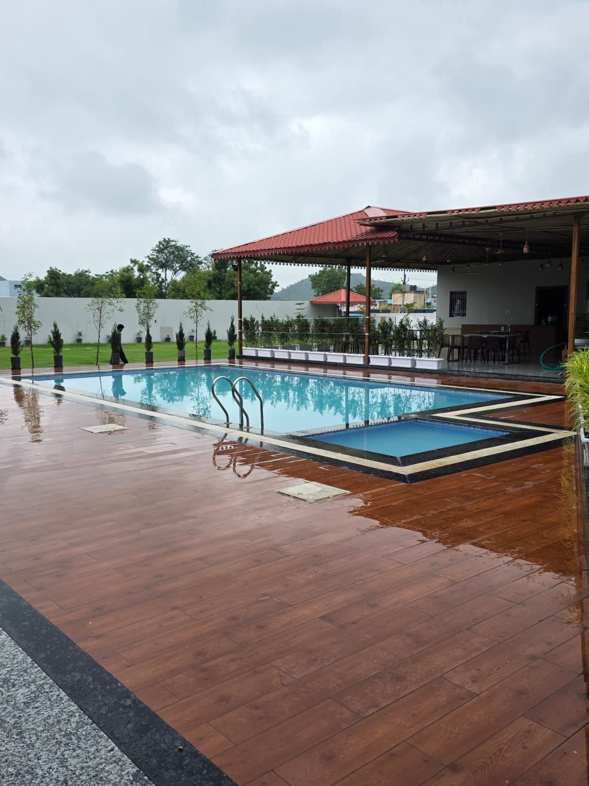 Wooden pool deck at The Ambay Villa Udaipur